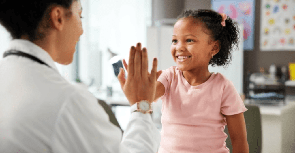 Girl high-fiving doctor